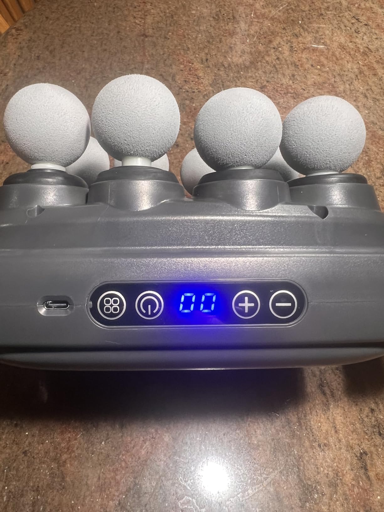 Handheld electronic device with foam handles on a brown surface