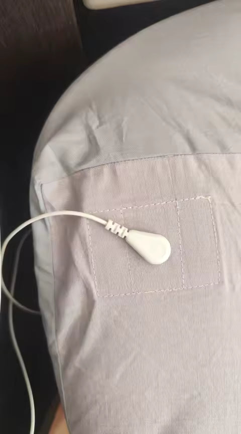 White earbud on a gray fabric surface