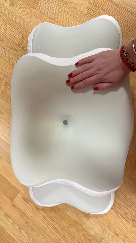 White plastic container with a hand on top, on a wooden floor