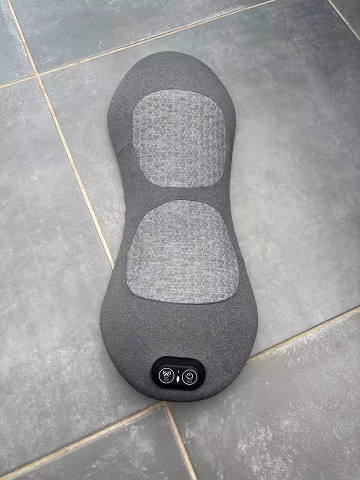 Gray massage pad on a tiled floor