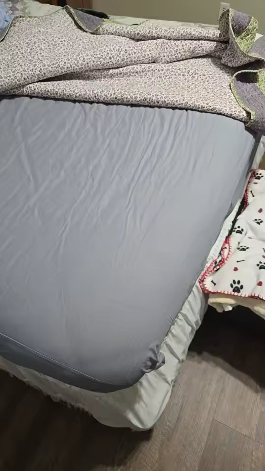 Gray mattress cover on a bed with floral bedding